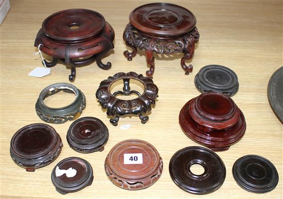 Thirteen assorted mainly Chinese hardwood vase stands, largest diameter 17cm, height 12cm